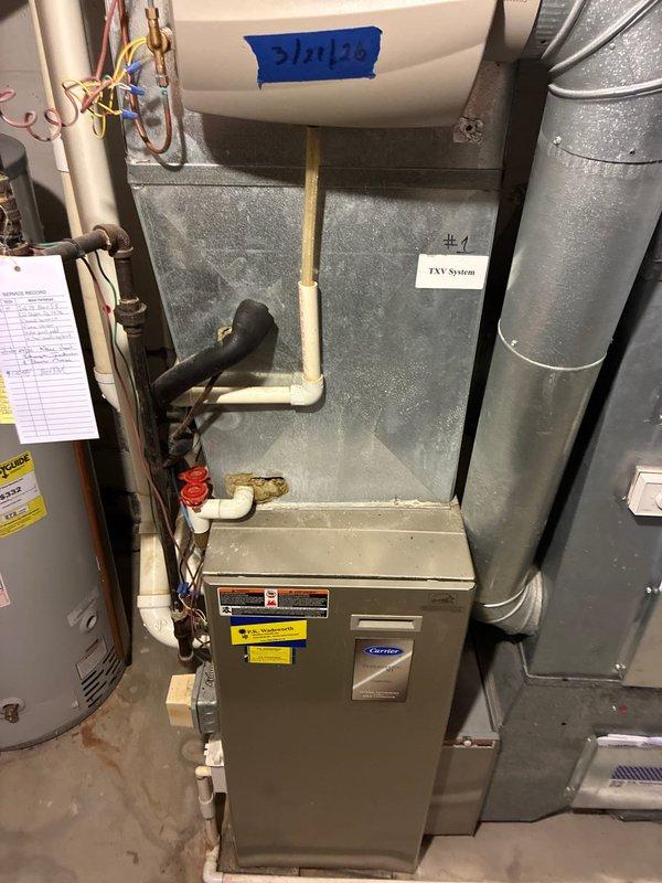 Evaluated existing Carrier furnace and HVAC system configuration in basement utility room and provided equipment replacement options for the smaller capacity system serving the right side of the residence. Assessed current installation including ductwork connections, refrigerant line routing, condensate drainage, and clearance requirements for future replacement considerations.
