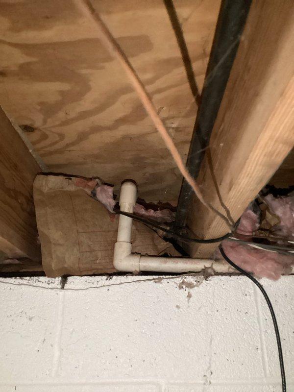 Responded to a service call for a heavily leaking 8-inch pipe connected to an outdoor spigot in the backyard. Upon inspection, identified significant corrosion and rust buildup on the horizontal supply line, with visible rust staining and active water discharge at the connection point. Accessed the plumbing infrastructure from the crawl space beneath the floor joists to assess the full extent of the leak and pipe deterioration. Documented the corroded pipe sections and compromised fittings showing heavy oxidation that had caused the failure in the outdoor spigot supply line.