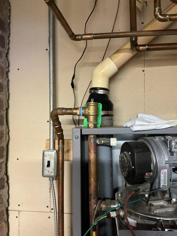 Completed installation and setup of new wall-mounted hydronic boiler system including all necessary piping connections, electrical integration, and safety components. Connected copper supply and return lines to the unit, installed expansion tank with pressure gauge, integrated zone valves, and established proper electrical connections to the control panel. Verified all plumbing connections are secure, system pressurized correctly, and digital control interface is functioning properly for optimal heating operation.