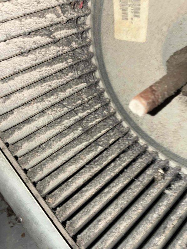 Responded to no cooling call on original 1980s HVAC system that trips breaker when switched from heat to cool mode. Upon inspection, found evaporator coil heavily clogged with dust and debris, restricting airflow significantly. Documented existing ductwork penetrations through foundation wall showing age-related deterioration and rust around collars. Identified copper refrigerant lines and coil housing with substantial dust accumulation throughout system. Explained that the breaker tripping is likely due to compressor overload caused by restricted airflow from the severely fouled evaporator coil, combined with age-related component failure in the outdoor condensing unit. Given the system's age of 40+ years and extent of deterioration, recommended full system replacement rather than repair. Customer expressed strong interest in replacement estimate.