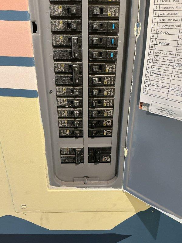 Completed electrical installation for exterior utility service upgrade. Installed new service panel with proper conduit routing from exterior meter enclosure through building envelope. Mounted weatherproof electrical boxes and meter housing on exterior siding with appropriate conduit connections running to grade level. Configured interior main breaker panel with updated circuit directory labeling all branch circuits including major appliances such as dryer, dishwasher, washer pump, kitchen receptacles, and office circuits. All conduit secured with proper clamps and brackets per code requirements. Verified all connections and tested panel operation.
