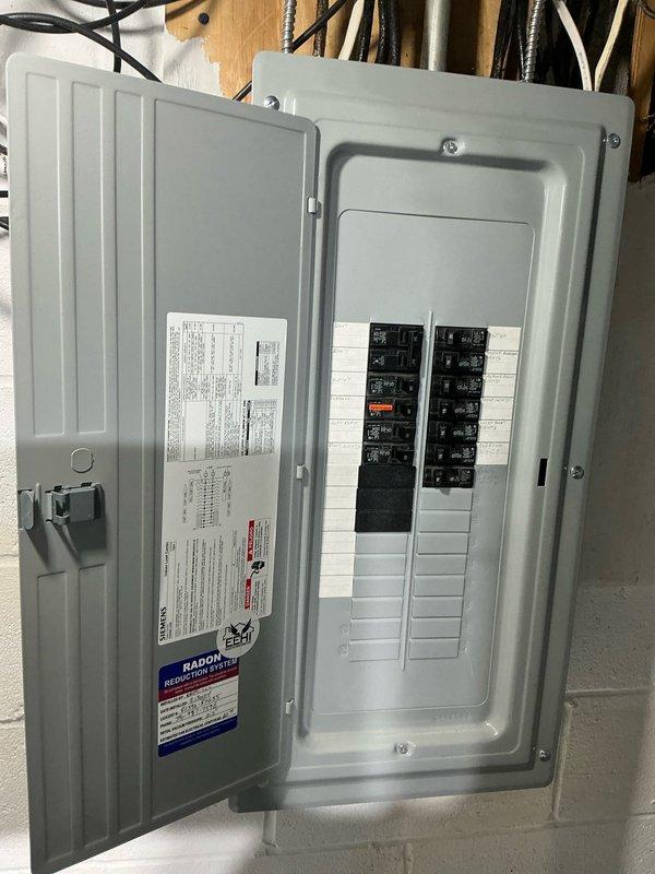Performed comprehensive assessment of non-functional forced air HVAC system in residential basement and provided detailed replacement estimate including both air conditioning and heat pump options. Documented existing gray metal furnace/air handler unit with ductwork, electrical panel configuration, and system layout to present customer with equipment replacement alternatives for their heating and cooling needs.