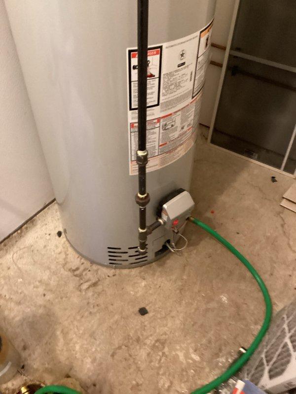 Completed scheduled maintenance on residential tanked water heater, performing a complete flush and fill procedure to remove sediment buildup and maintain optimal system performance. Drained the unit using a garden hose, flushed the tank thoroughly to clear accumulated mineral deposits, and refilled the system. Inspected all copper supply lines, brass valves, and fittings for proper operation and verified the galvanized vent pipe connection at the top of the unit. All plumbing connections remained secure with no signs of leaks or corrosion. System was returned to normal operation with proper water flow and temperature function confirmed.