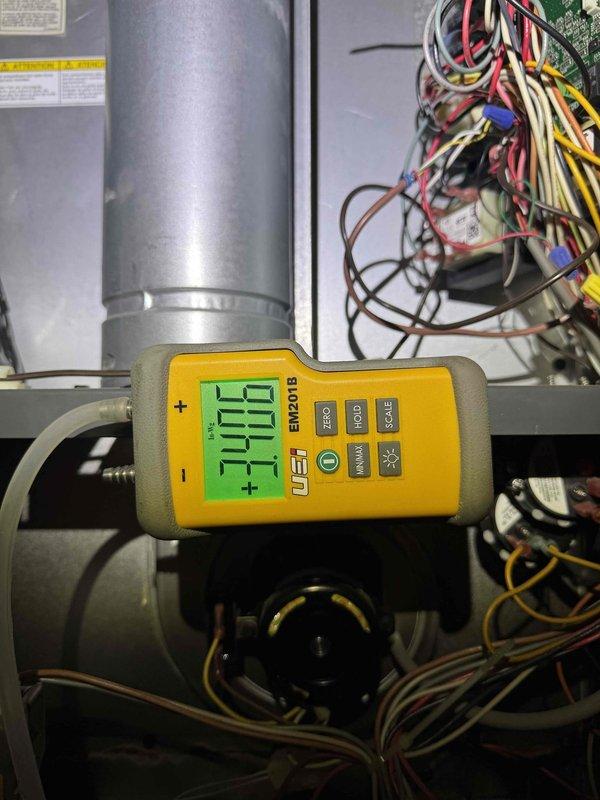 Responded to no heat call on residential furnace less than 10 years old. Upon inspection, discovered burner assembly showing signs of corrosion and discoloration along mounting seam, indicating potential combustion or venting issues. Performed diagnostic testing using digital multimeter to measure system parameters and verify proper electrical operation. Documented internal equipment condition with photos showing burner tubes, electrical connections, and blower assembly. Contacted customer to discuss findings and recommend next steps for repair.