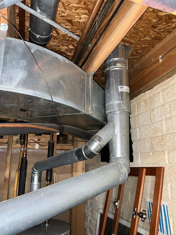 Completed comprehensive estimate for full HVAC system replacement on aging 1990s-era equipment. Evaluated existing basement-mounted air handler with galvanized sheet metal ductwork distribution system and exterior cylindrical condenser unit installed at foundation level. Documented current system configuration including main plenum, flexible duct connections, and mechanical equipment placement. Presented multiple replacement options for complete heating and cooling system upgrade to modern, energy-efficient equipment.