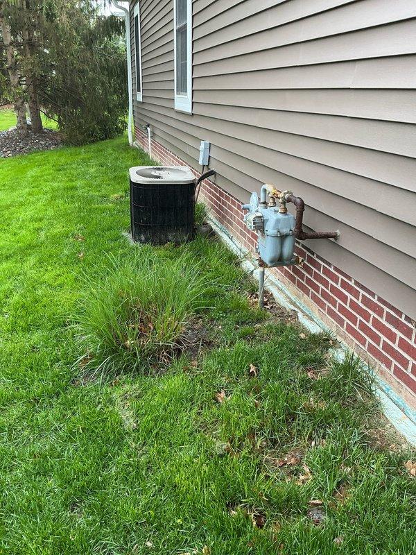 Completed comprehensive estimate for full HVAC system replacement on aging 1990s-era equipment. Evaluated existing basement-mounted air handler with galvanized sheet metal ductwork distribution system and exterior cylindrical condenser unit installed at foundation level. Documented current system configuration including main plenum, flexible duct connections, and mechanical equipment placement. Presented multiple replacement options for complete heating and cooling system upgrade to modern, energy-efficient equipment.