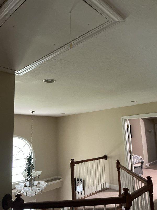 Conducted on-site assessment for ceiling fan installation in residential foyer area with tray ceiling and existing lighting configuration. Evaluated electrical requirements, mounting location feasibility, and structural support considerations for new fixture installation above staircase landing.