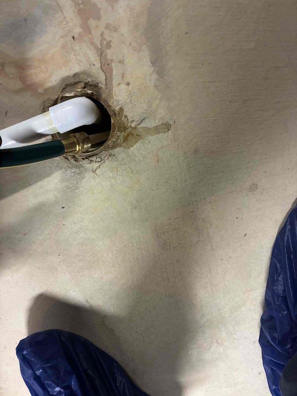 Completed comprehensive HVAC maintenance on heating and cooling systems, along with hot water tank servicing. Inspection revealed significant corrosion on outdoor unit capacitor and associated electrical connections, with visible weathering on condenser components from environmental exposure. Documented water damage and staining around plumbing penetration point, indicating previous or ongoing moisture intrusion requiring monitoring.