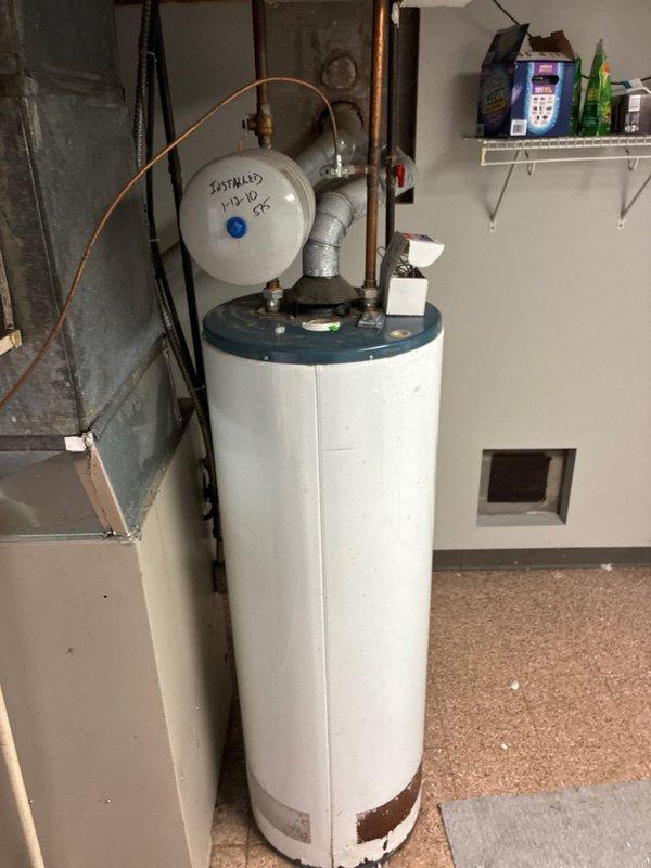Conducted comprehensive site assessment for full HVAC system replacement, evaluating existing outdoor condensing unit and indoor equipment configuration. Documented current electrical service connection at exterior meter location, noting existing conduit routing and junction box placement for proper electrical sizing requirements. Assessed aging water heater with visible corrosion at base and evaluated mechanical room layout including existing ductwork, expansion tank configuration, and available space for new equipment installation. Provided multiple system replacement options addressing both heating and cooling components based on current equipment condition and utility infrastructure.