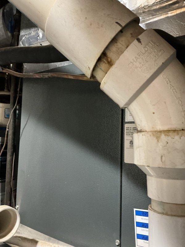 Completed comprehensive cooling system tune-up on Goodman HVAC unit. Performed standard maintenance inspection of furnace and air handler components, documenting existing rust staining on top panel indicating previous moisture exposure and age-related wear on PVC condensate drainage system with visible discoloration at pipe joints. All accessible equipment photographed and system evaluated for proper operation ahead of cooling season.