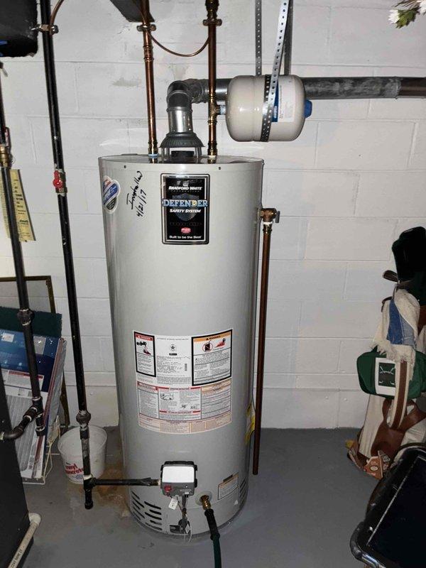Performed routine maintenance flush and fill procedure on Bradford White residential gas water heater equipped with Defender Safety System. Drained sediment and mineral buildup from tank bottom through drain valve to restore heating efficiency and extend unit lifespan. Refilled tank with fresh water and verified proper operation of all safety systems including temperature and pressure relief valve. Confirmed adequate clearance around unit for continued maintenance access and inspected copper supply lines, expansion tank connections, and venting system for proper configuration. All components functioning within normal parameters upon completion.