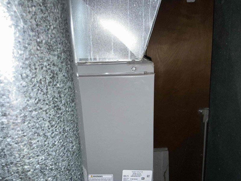 Conducted on-site assessment of residential air conditioning system reported as damaged by hail. Evaluated indoor HVAC unit located in utility closet, documenting existing equipment condition including furnace cabinet, ductwork with visible condensation, and electrical panel components. Provided replacement options and estimates for hail-damaged AC system to restore cooling functionality.