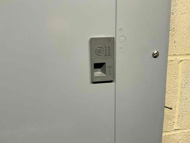 Conducted site assessment for downstairs air conditioning system replacement, focusing on condenser placement options on the left side of the property. Documented electrical panel configuration and recorded critical measurements including clearance dimensions and equipment spacing requirements for proper installation planning.