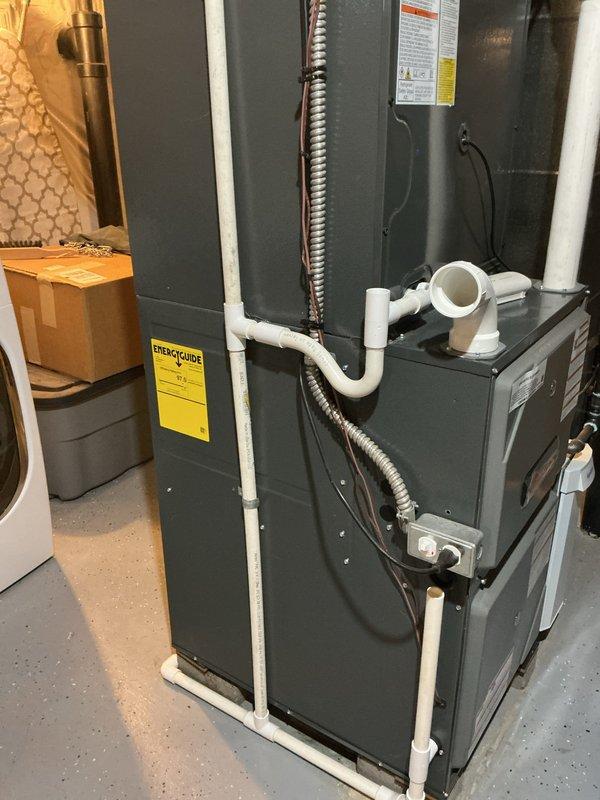 Responded to concern regarding condensate drain line configuration on furnace unit. Upon inspection, confirmed that PVC piping connected to the condensate drain was installed with upward slope, which prevents proper gravity drainage and could lead to water backup and potential system shutdown. Documented existing piping configuration with photographs showing the improper angle of drain line installation. Verified carbon monoxide detector present and functional in utility area per safety protocols.
