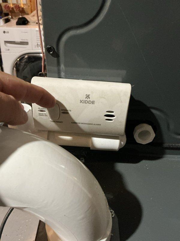 Responded to concern regarding condensate drain line configuration on furnace unit. Upon inspection, confirmed that PVC piping connected to the condensate drain was installed with upward slope, which prevents proper gravity drainage and could lead to water backup and potential system shutdown. Documented existing piping configuration with photographs showing the improper angle of drain line installation. Verified carbon monoxide detector present and functional in utility area per safety protocols.