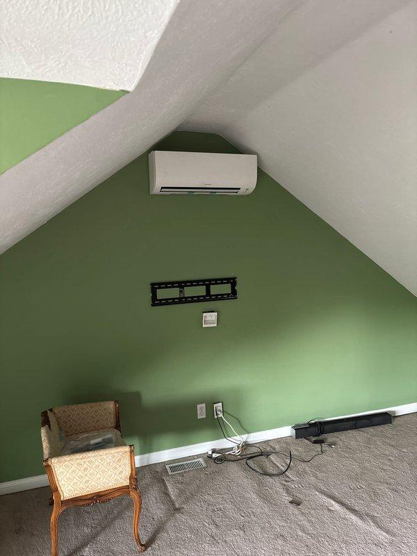 Completed installation of a two-head ductless mini-split system with indoor air handler units mounted in interior living spaces and exterior condensing unit installed on building exterior. Routed refrigerant lines, condensate drainage, and electrical connections through exterior wall penetrations, securing all piping runs along the building's siding. Successfully commissioned system, verified proper operation of both zones, and collected outstanding balance upon project completion.