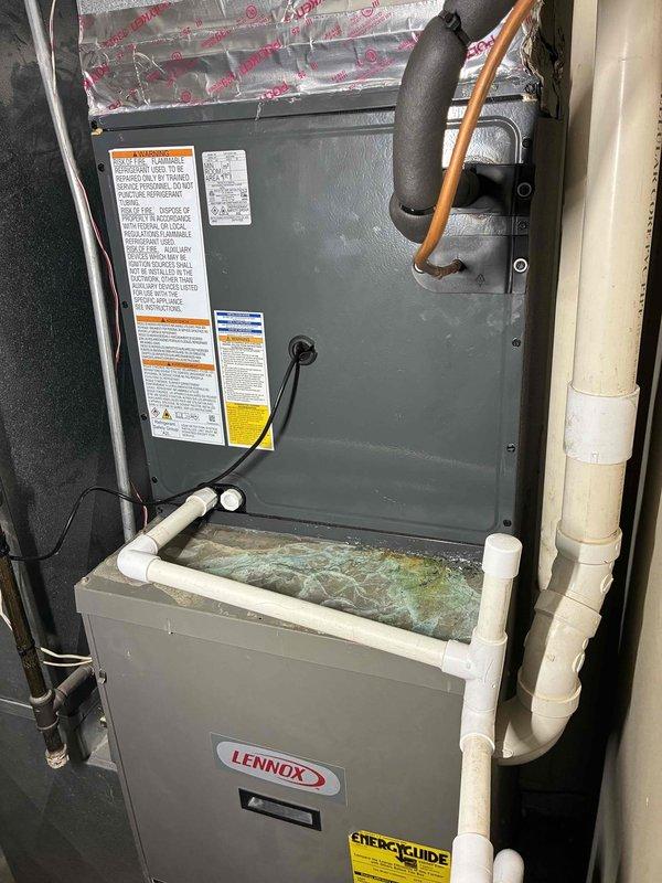 Completed full air conditioning system installation with Lennox equipment. Installed new AC unit with refrigerant lines properly connected and insulated, integrated with existing furnace infrastructure. Verified system operation with temperature readings showing proper cooling performance at 59.6°F supply air temperature. All ductwork connections secured with proper insulation, condensate drainage system confirmed operational, and unit tested for optimal performance.