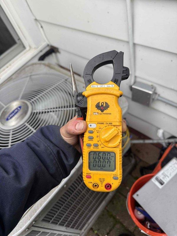 Completed scheduled preventive maintenance on residential cooling system. Performed inspection and servicing of indoor air handler components including condensate drain lines and PVC piping connections in basement mechanical room. Conducted outdoor condenser unit diagnostics using clamp meter to verify proper electrical draw and compressor amperage on Samsung unit, confirming system operating within manufacturer specifications.