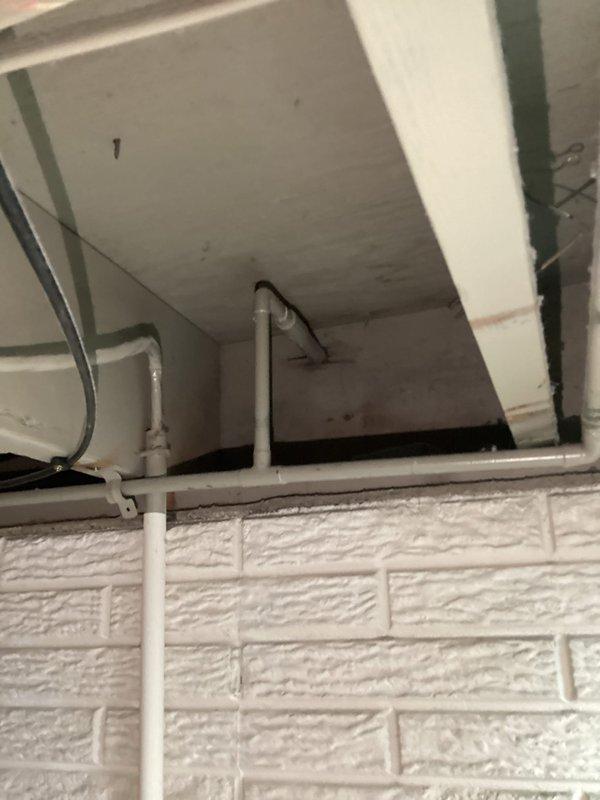 Performed site assessment for outdoor spigot relocation on residential property. Evaluated existing spigot location on exterior wall near deck area and inspected interior plumbing routing through utility space to determine feasibility and provide relocation quote. Documented current installation configuration including exterior siding penetration point and interior supply line path along ceiling infrastructure.