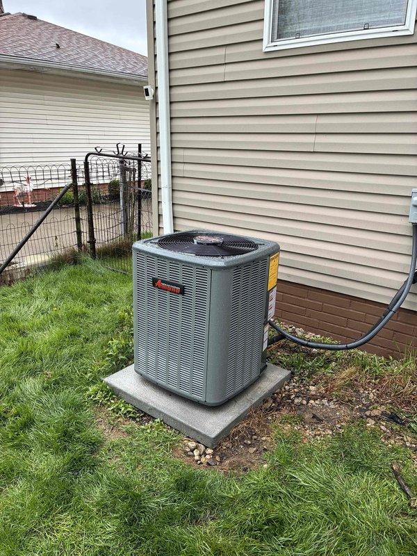 Completed full HVAC system installation including new outdoor condensing unit and indoor evaporator coil. Installed gray A2L-rated air conditioning condenser on existing concrete pad in residential backyard with proper clearances from structure and property line. Ran electrical conduit along exterior wall to power unit per code requirements. Connected refrigerant lines using brass service valves and properly insulated copper line set to prevent condensation. System charged with R32 refrigerant per manufacturer specifications. Verified all electrical connections secure, tested system operation, and confirmed proper airflow and cooling performance. Installation includes updated A2L safety-compliant equipment with appropriate labeling and documentation.