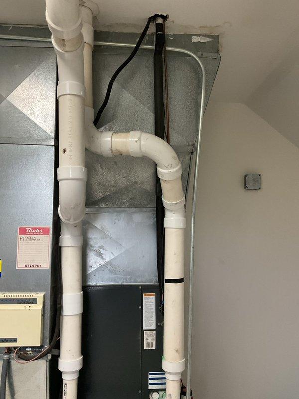 Responded to service call for air conditioning system inspection due to reported hail damage. Upon arrival, performed comprehensive visual examination of Goodman HVAC system and associated components in basement mechanical room. Inspected exterior and interior equipment, condensate drainage system, electrical connections, and all accessible ductwork. Documented equipment condition through photographic assessment showing furnace/air handler unit, PVC piping, electrical conduit, and mounting hardware all intact with no visible signs of hail damage, impact marks, or compromised components. System components appear to be in proper working condition with secure installations and appropriate safety labeling present.