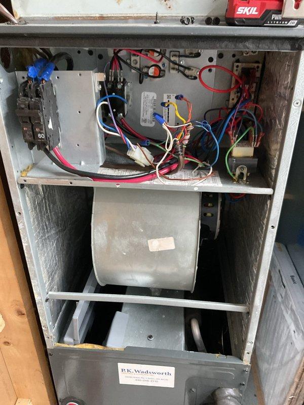 # HVAC Cooling Maintenance Summary

Completed scheduled preventive maintenance on residential cooling system as part of ongoing service plan. Performed comprehensive inspection of furnace unit and associated HVAC components, including examination of electrical control panel, blower motor assembly, and all accessible mechanical systems.

# Detailed Work Performed

Accessed interior compartments of HVAC unit to conduct thorough inspection of electrical and mechanical components. Examined control panel wiring connections, verifying proper terminations of all colored wire runs including power and control circuits. Inspected dual circuit breakers rated at 60 amps for proper operation and secure mounting. Evaluated condition of blower motor compartment and associated ductwork connections.

Assessed overall system condition, noting general operational wear consistent with unit age. Verified all manufacturer specification labels and safety warnings remain legible and properly affixed to unit e