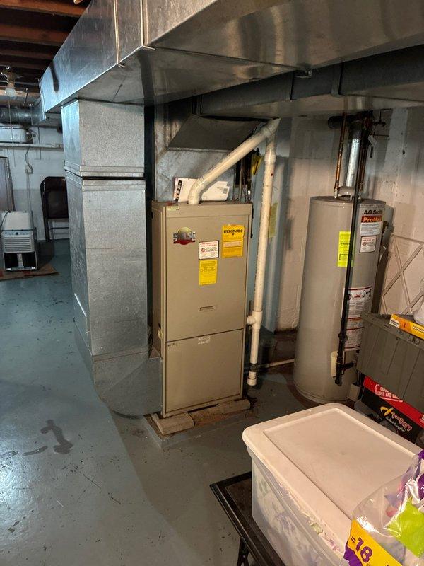 Conducted comprehensive assessment of existing HVAC system and water heating equipment in basement mechanical room to provide full system replacement options. Evaluated current furnace unit with associated ductwork, ventilation hood, and PVC venting configuration, along with existing water heater installation. Documented equipment conditions, clearances, and mechanical room layout including all supply and return ductwork, gas piping with shutoff valves, and existing electrical connections to determine optimal replacement specifications and installation requirements.