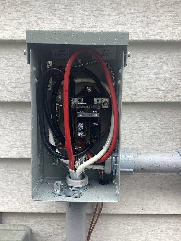 Replaced existing 100-amp electrical service panel with new code-compliant installation per NEC requirements. Installation included four combination smoke/carbon monoxide detectors hardwired to the panel and integrated whole-house surge protection device. All circuit breakers were properly installed and labeled, with organized wire routing including main service conductors, neutral bus connections, and ground bar terminations. Panel was mounted on exterior with appropriate weather-resistant enclosure and conduit connections for service entrance cables.