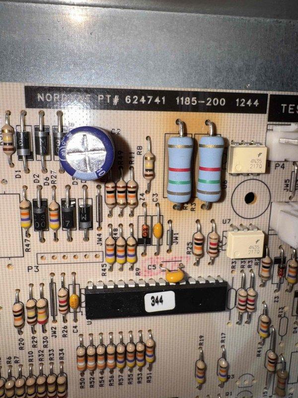 Responded to no heat call on Nordyne furnace system. Upon arrival, performed diagnostic inspection of unit and control board assembly. Inspected circuit board PT# 624741 1185-200 1244, examining all electronic components including resistors, capacitors, and integrated circuits for signs of failure or damage. Control board showed age-related discoloration but components appeared intact and properly mounted. Completed system diagnostics and restored heating operation to unit.