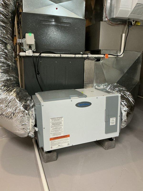 Completed comprehensive maintenance service on dual cooling system including ductless mini-split and central air conditioning unit, along with hot water tank inspection. Performed thorough inspection of basement-mounted HVAC equipment, including air handler with humidifier component, plenum chamber, and associated ductwork system. All flexible and rigid ductwork connections verified secure, equipment operational with no visible signs of deterioration or damage noted.