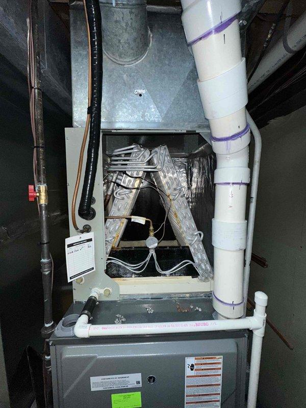 # HVAC Cooling Maintenance Completed

Performed comprehensive cooling system maintenance on residential split-system air conditioning unit. Conducted thorough inspection of outdoor condenser unit positioned on concrete pad, verifying proper clearance and level installation. Checked electrical disconnect, examined refrigerant line insulation integrity, and inspected conduit connections. 

Accessed indoor air handler and evaporator coil assembly located in basement mechanical room. Removed furnace access panel to inspect internal cooling components, including evaporator coil and associated ductwork. Verified proper operation of condensate drain system with PVC drain lines. Inspected refrigerant line connections at indoor unit, confirming black insulation wrap on suction line remains intact.

System operating within normal parameters. All components inspected and found to be functioning properly for continued cooling season operation.
