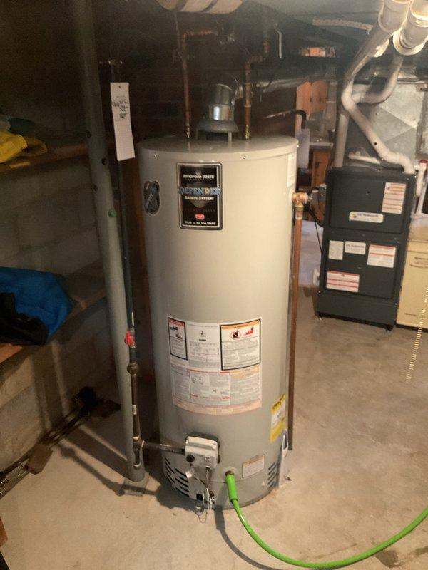 Performed routine maintenance on residential water heating system, completing a full flush and fill procedure on the Bradford White water heater unit. Drained sediment buildup from tank using drain valve, refilled system, and verified proper operation of all components including pressure relief valve and gas control assembly.