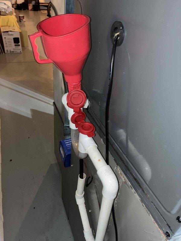 Completed comprehensive HVAC cooling system maintenance including condensate drain line treatment and electrical diagnostics. Applied drain line cleaning solution through funnel assembly into PVC condensate system and performed electrical testing with digital multimeter to verify proper system operation and component functionality.