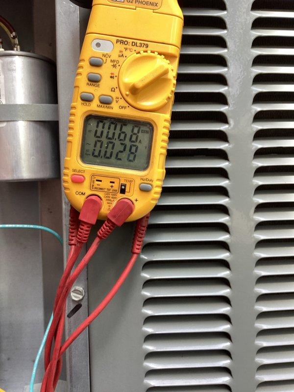 Completed comprehensive HVAC cooling system maintenance including condensate drain line treatment and electrical diagnostics. Applied drain line cleaning solution through funnel assembly into PVC condensate system and performed electrical testing with digital multimeter to verify proper system operation and component functionality.