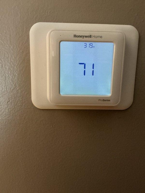 Completed comprehensive cooling system maintenance inspection. Verified thermostat operation and calibration at 71°F setpoint, confirming proper temperature control functionality. Measured supply register airflow temperature at 84.9°F using digital multimeter to assess system performance and cooling output. All components operating within normal parameters.