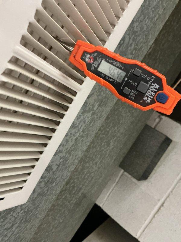 Completed comprehensive cooling system maintenance inspection. Verified thermostat operation and calibration at 71°F setpoint, confirming proper temperature control functionality. Measured supply register airflow temperature at 84.9°F using digital multimeter to assess system performance and cooling output. All components operating within normal parameters.