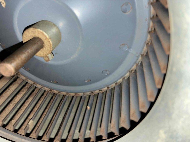 Performed routine HVAC cooling maintenance on residential condensing unit. Inspected condenser fan motor and housing, verifying proper mounting and electrical connections per manufacturer specifications including catalog number 83396. Examined motor shaft, bearings, and cooling fin assembly for wear and operational integrity. Cleaned accumulated dust and debris from cooling fins to ensure optimal heat dissipation and system efficiency. Verified all safety labels and electrical specifications remain legible and compliant. Unit operating within normal parameters upon completion of maintenance service.