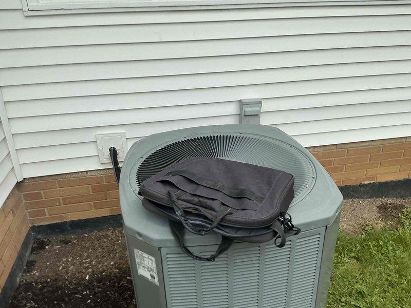 Completed comprehensive evaluation of existing residential HVAC system for full replacement estimate. Assessed outdoor condensing unit positioned on concrete pad adjacent to structure, noting current equipment configuration and installation parameters. Inspected indoor air handler components including existing PVC condensate drainage system and ventilation piping. Documented current system layout, equipment specifications, and spatial constraints to provide accurate replacement options for complete heating and cooling system upgrade.