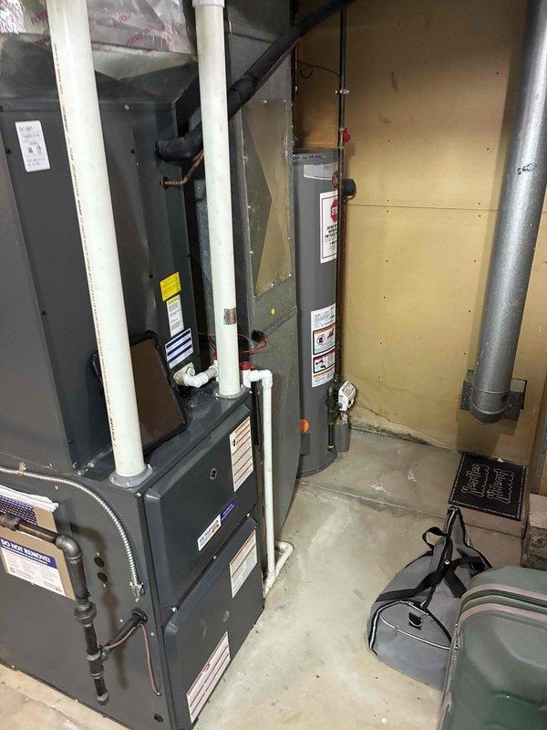 # HVAC Cooling System Maintenance

Completed scheduled preventive maintenance on residential air conditioning system. Inspected evaporator coils and noted moderate accumulation of dirt, debris, and organic material between fins with visible discoloration. Evaluated furnace unit, water heater, and associated ductwork in mechanical room, confirming all equipment labels and safety placards remain intact and legible. System components operational with standard residential HVAC infrastructure functioning as designed.