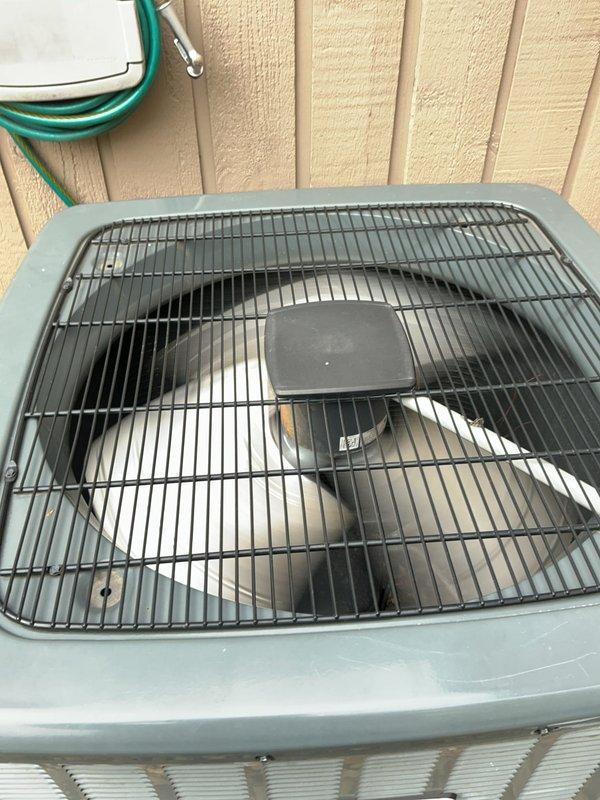 Completed routine HVAC cooling system maintenance on residential air conditioning unit. Inspected Copeland Scroll compressor equipped with CoreSense diagnostic module, verified all diagnostic indicators showed normal operation with no fault codes present, and confirmed proper electrical connections. Examined outdoor condenser unit, checked fan motor operation, verified protective grille integrity, and assessed overall system condition with all components functioning within normal parameters.