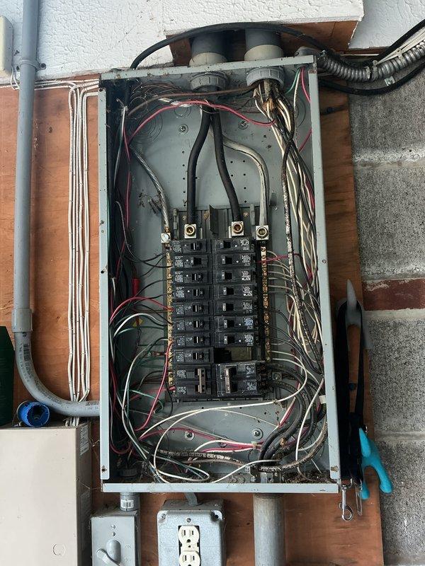 Conducted electrical inspection of residential panel box and documented system configuration. Verified circuit breaker arrangement, bus bar connections, and wiring routing throughout the panel, confirming proper installation of branch circuits and grounding conductors. Photographed electrical panel and mechanical room area for record-keeping purposes.