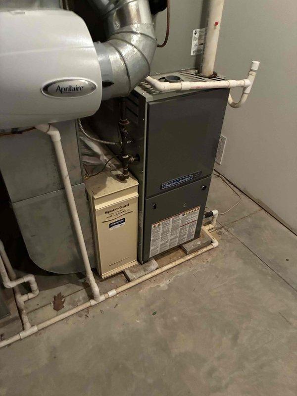 Completed comprehensive maintenance and tune-up service on two HVAC systems, both over 10 years old, located at the same property. Performed full system inspection on American Standard unit (Model 4A7A3036G1000NIB, Serial 16154LLRAF) and secondary system including basement-mounted furnace with integrated Aprilaire humidifier. Conducted coil cleaning on both air conditioning units, removing accumulated dirt and debris from evaporator and condenser coils to restore optimal heat transfer efficiency. Inspected all electrical connections, tested capacitors, and verified proper amperage draw on compressor and fan motors. Checked refrigerant levels and system pressures on both units. Cleaned condensate drain lines and verified proper drainage. Inspected ductwork connections and sealed where necessary. Tested thermostat operation and system cycling. Replaced air filters and cleaned blower assemblies. All systems operational and running within manufacturer specifications upon completion.