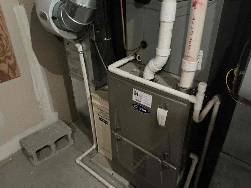 Completed full HVAC system replacement due to cracked heat exchanger in existing furnace. Installed new American Standard furnace with proper PVC venting and condensate drainage, along with Space-Gard air cleaner system. Presented multiple system options to address failed equipment and ensure safe, efficient heating operation.