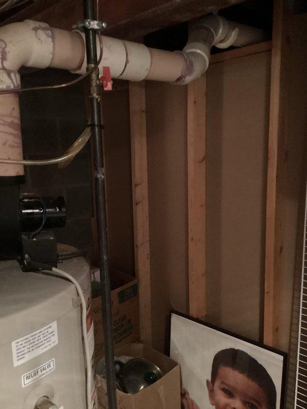Conducted site assessment of existing water heating system in unfinished basement utility area. Documented current tank-style water heater installation, including all supply lines, venting configuration, and available space for potential equipment upgrade. Photographed existing plumbing connections, gas lines, and surrounding mechanical systems to provide accurate quote for replacement options including traditional tank water heater and tankless water heater alternatives.
