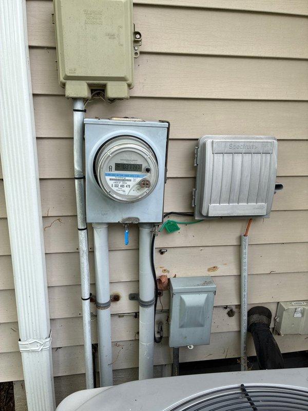 Completed HVAC system replacement installation including exterior condenser unit with proper electrical service connections and interior electrical panel upgrades. Installed new electrical meter enclosure, conduit routing, and associated utility boxes to support the new air conditioning system, ensuring all components meet current electrical code requirements for residential HVAC applications.