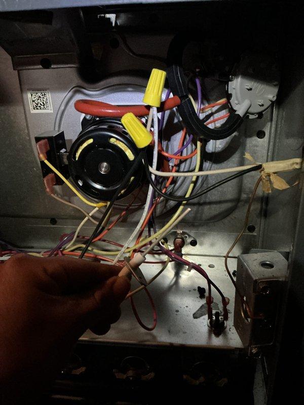 Completed annual maintenance visit on residential heating and cooling system including both furnace and air conditioning units per service protection plan agreement. Performed comprehensive inspection of outdoor Amana condenser unit, verifying proper operation of compressor, fan motor, and electrical connections. Inspected indoor furnace components including blower motor assembly, control board wiring, and safety connections with yellow wire nuts securing multiple circuit groups. All electrical connections tested and found secure, system controls operating within normal parameters, and both heating and cooling equipment functioning properly at time of service.