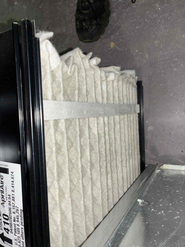 Completed routine cooling maintenance on HVAC system. Inspected and documented air filter condition, showing normal dust accumulation on pleated media within housing. Performed electrical diagnostics on outdoor unit using digital multimeter, recording voltage readings of 522V and 172V at disconnect panel to verify proper power supply and system operation.