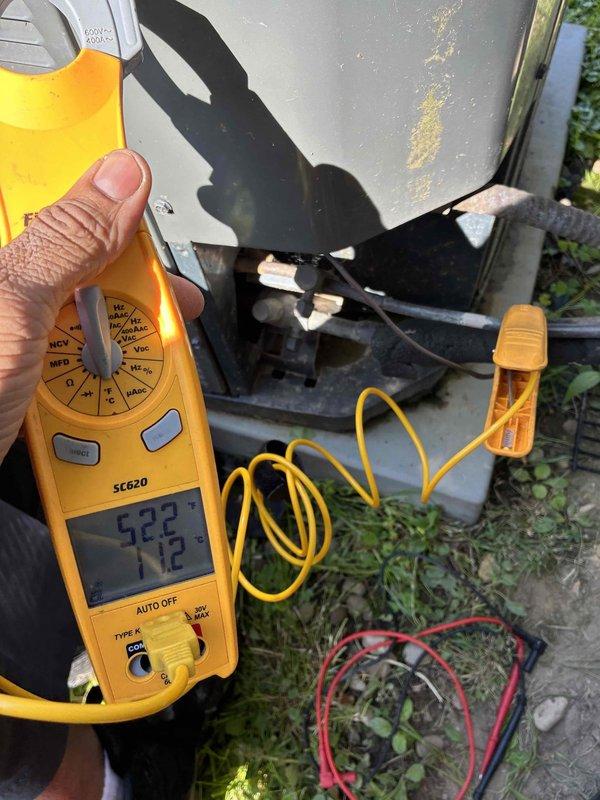 Completed routine cooling maintenance on HVAC system. Inspected and documented air filter condition, showing normal dust accumulation on pleated media within housing. Performed electrical diagnostics on outdoor unit using digital multimeter, recording voltage readings of 522V and 172V at disconnect panel to verify proper power supply and system operation.