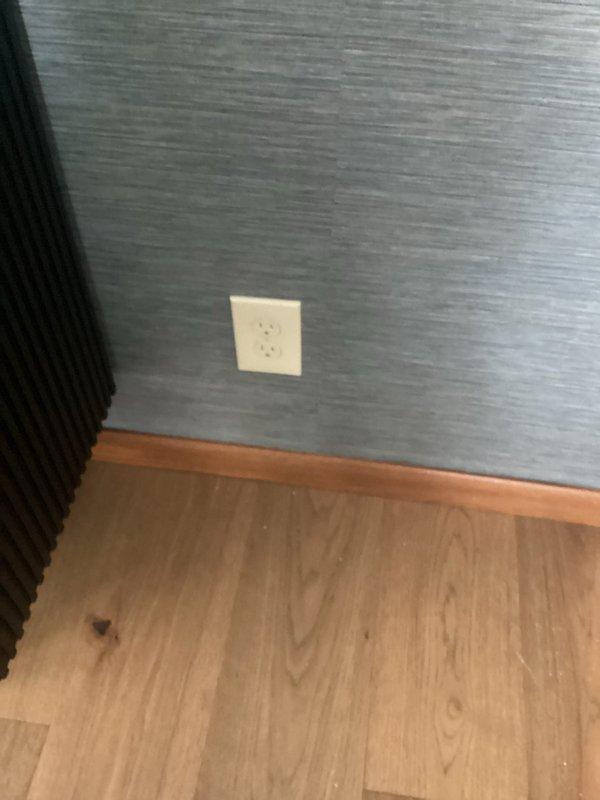 Separated a standard electrical outlet from GFCI protection and installed a new independent receptacle. Installed outlet above countertop in kitchen area with proper wall plate, and added a second outlet in adjacent room with blue-gray textured wall covering near baseboard trim. Both receptacles were properly wired, tested for correct polarity and grounding, and verified to be functioning safely per NEC standards.