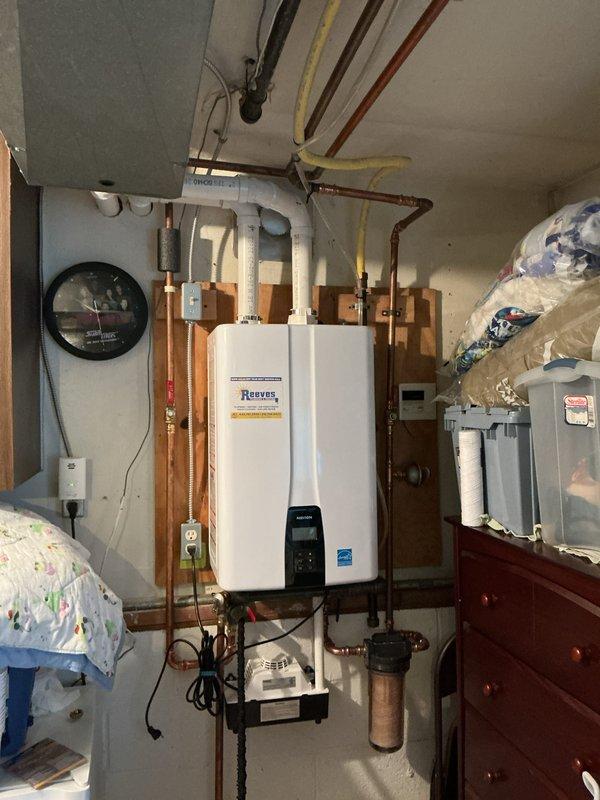 Performed routine maintenance flush on Reeves brand tankless water heater unit. Completed descaling procedure by circulating cleaning solution through the heat exchanger to remove mineral buildup and scale deposits. Isolated unit using service valves, connected flushing equipment, and ran cleaning cycle per manufacturer specifications. Inspected all copper supply and return lines, verified proper operation of isolation valves, and checked digital control display for error codes. Confirmed unit returned to normal operating parameters upon completion. System tested and operating efficiently.
